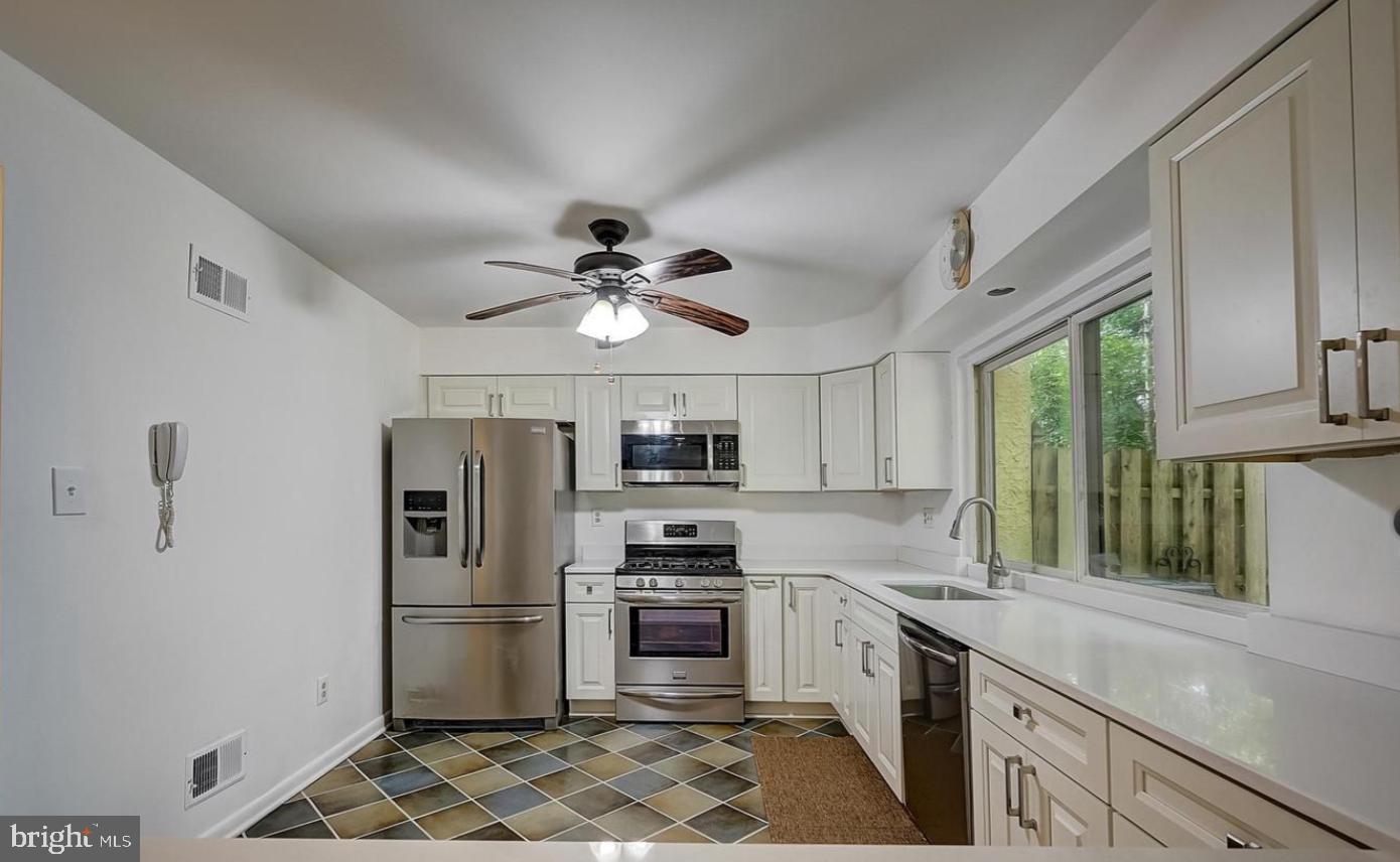 5 Christopher Road Voorhees, NJ 08043 - Photo 3 of 31 a kitchen with stainless steel appliances a refrigerator a stove a sink and a microwave