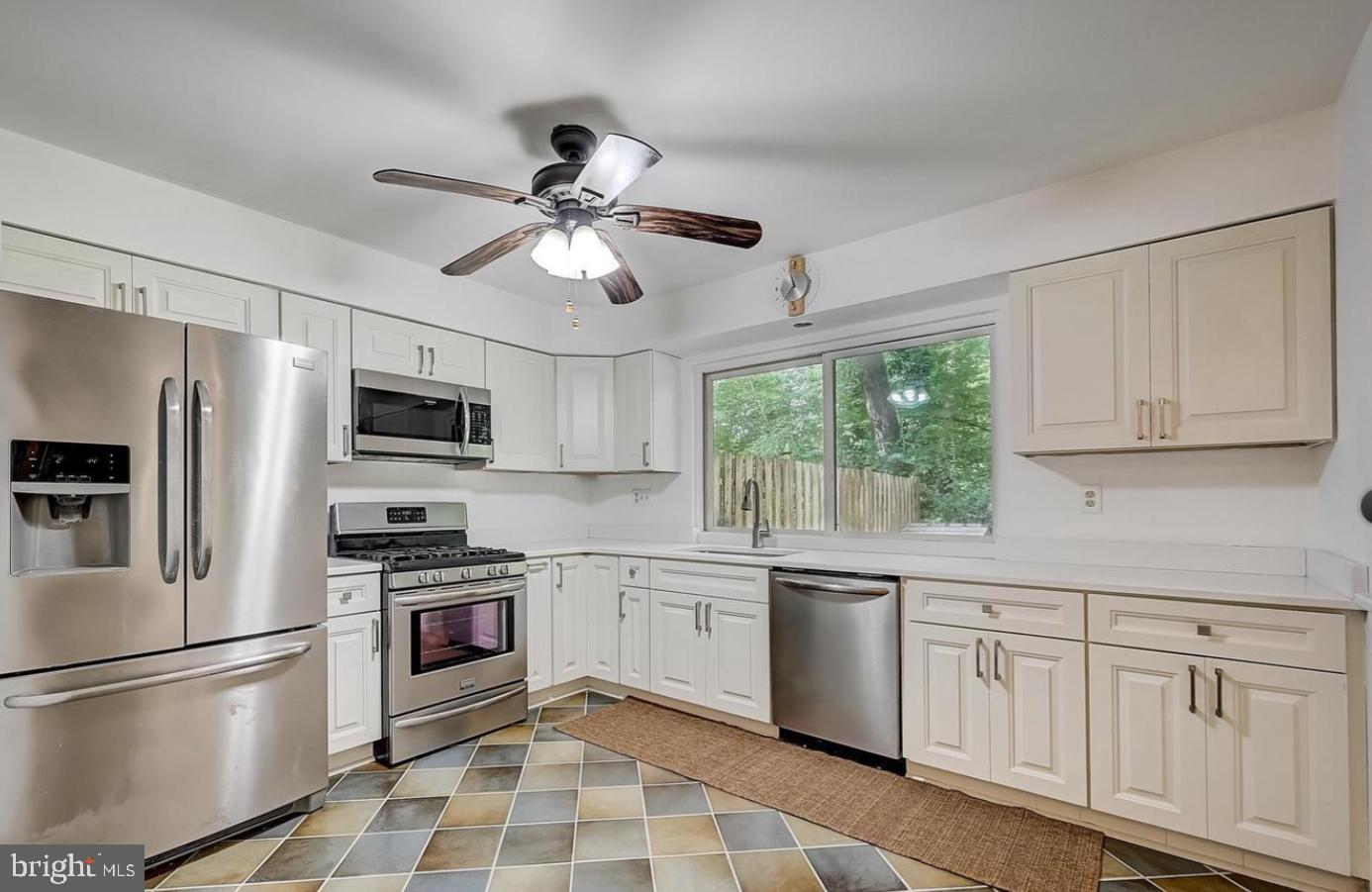 5 Christopher Road Voorhees, NJ 08043 - Photo 6 of 31 a kitchen with white cabinets stainless steel appliances and a window