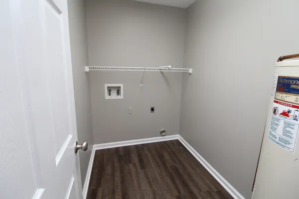 a view of a room with wooden floor
