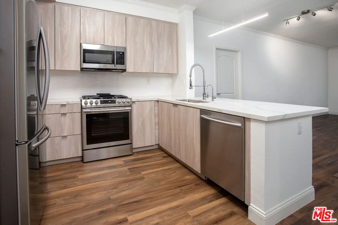 5710 Crescent Park East, Unit 209 Playa Vista, CA 90094 - Photo 12 of 29 a kitchen with stainless steel appliances a stove microwave and sink