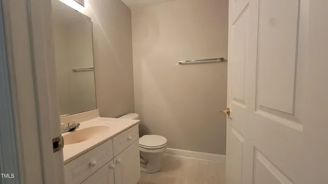 a white toilet sitting next to a bathroom sink