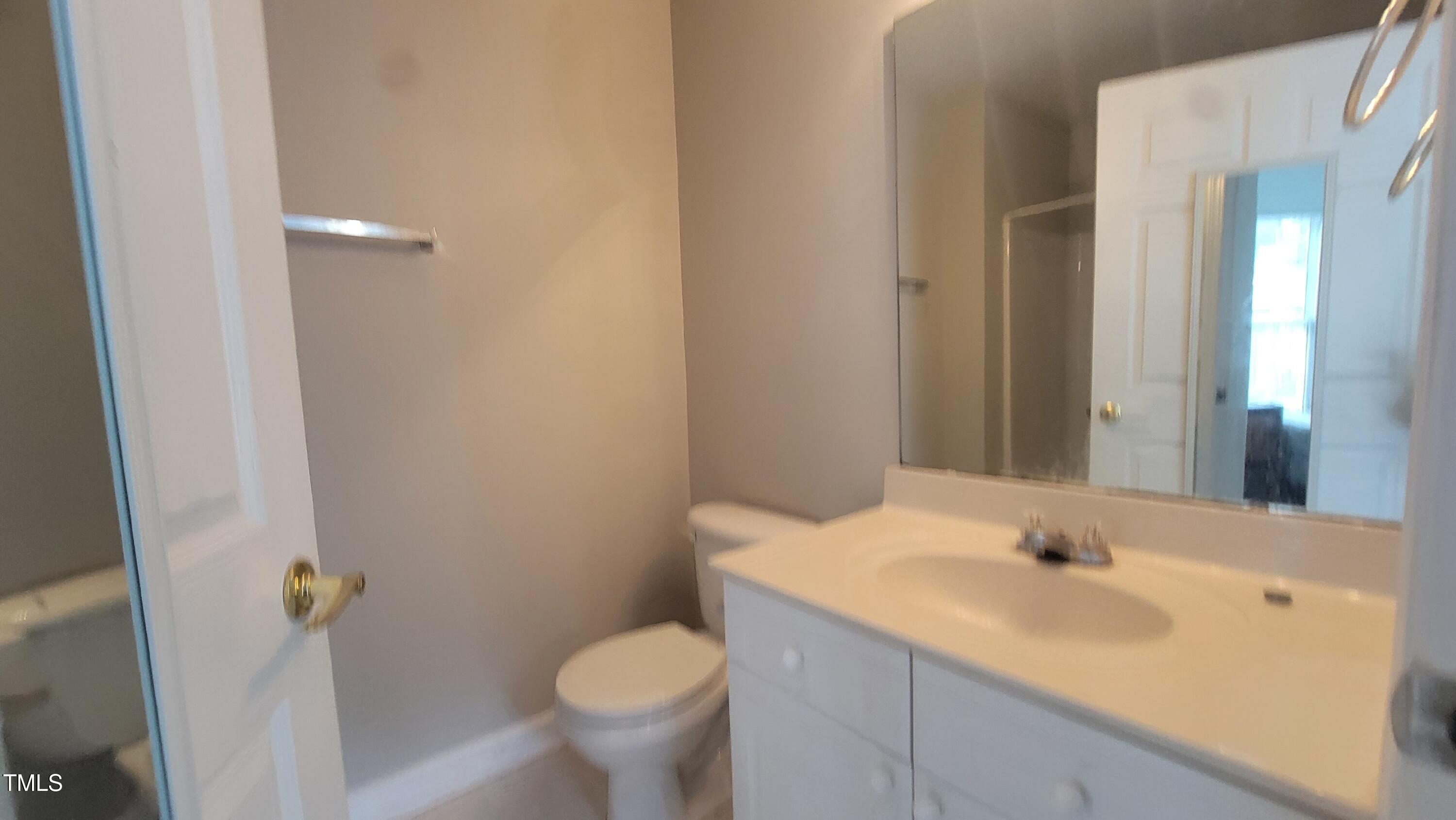 929 Morreene Road, Unit A13 Durham, NC 27705 - Photo 14 of 18 a bathroom with a sink and mirror with toilet
