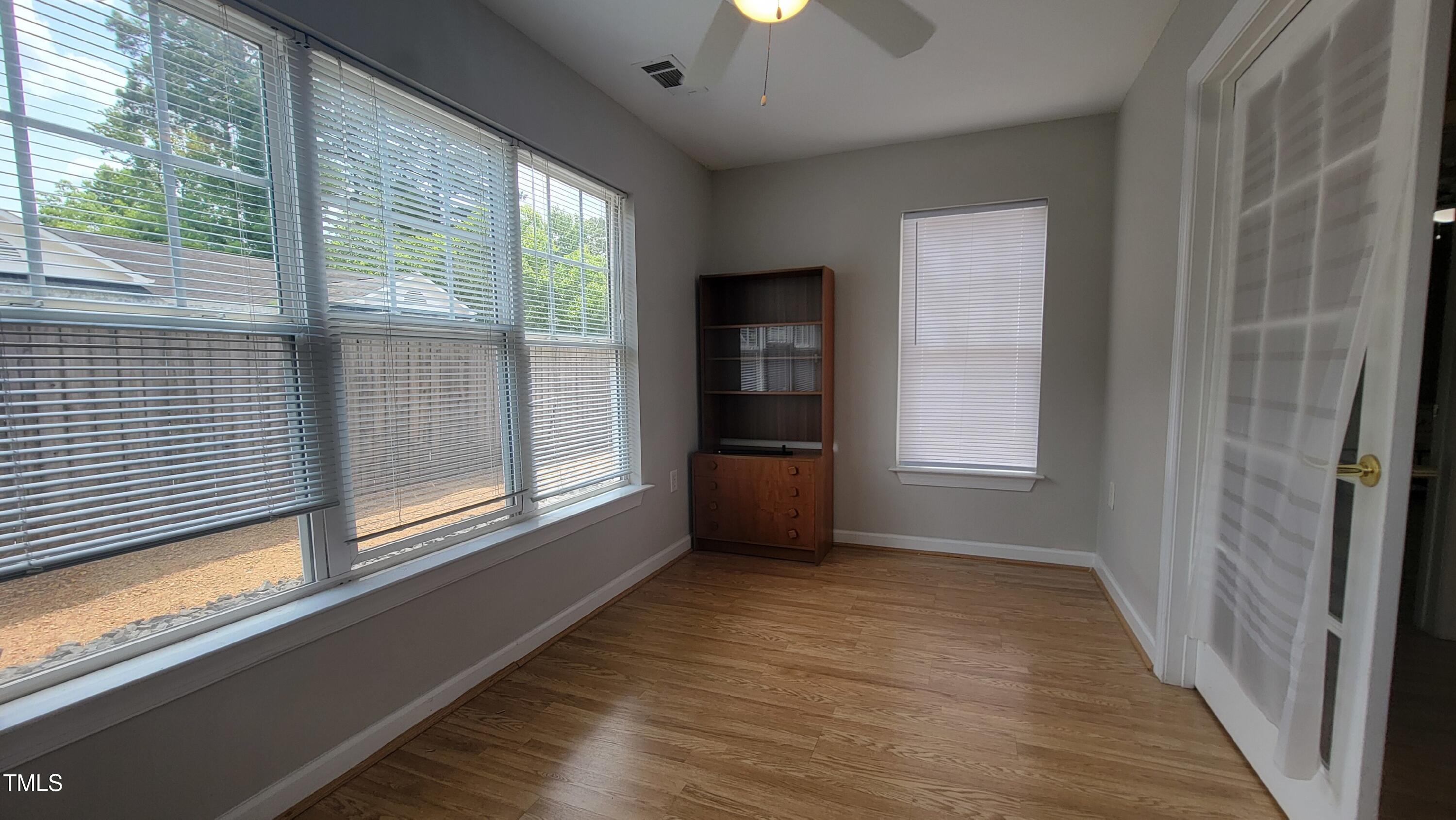 929 Morreene Road, Unit A13 Durham, NC 27705 - Photo 16 of 18 a view of an empty room with a window and wooden floor