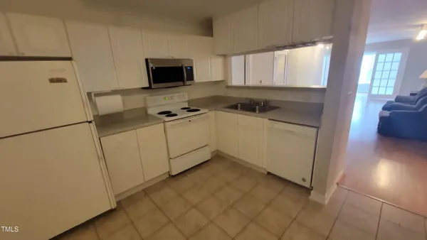a kitchen with stainless steel appliances a refrigerator sink and cabinets