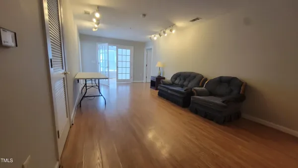 a living room with furniture and a wooden floor