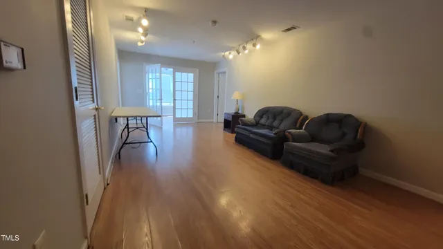 a living room with furniture and a wooden floor