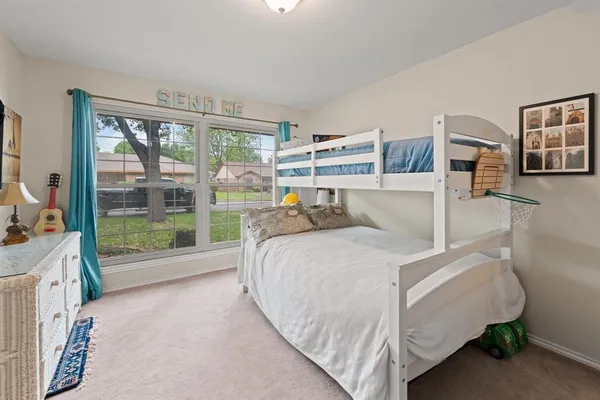a bed room with a bed and a large window