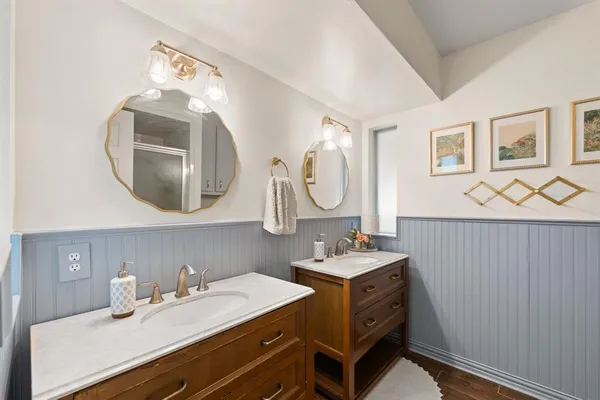 a bathroom with a double vanity sink mirror and