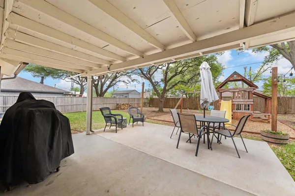 a view of a patio with table and chairs and couches with wooden floor