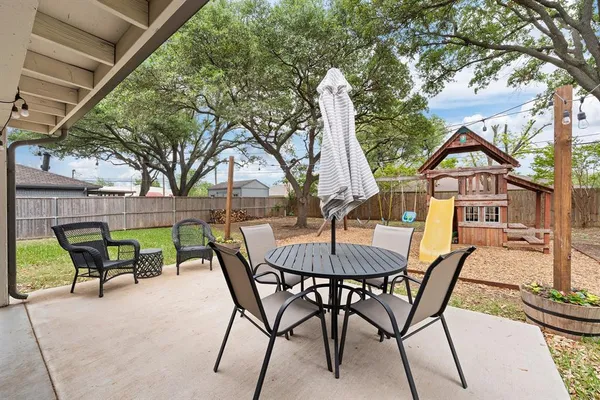 a view of a patio with a table and chairs