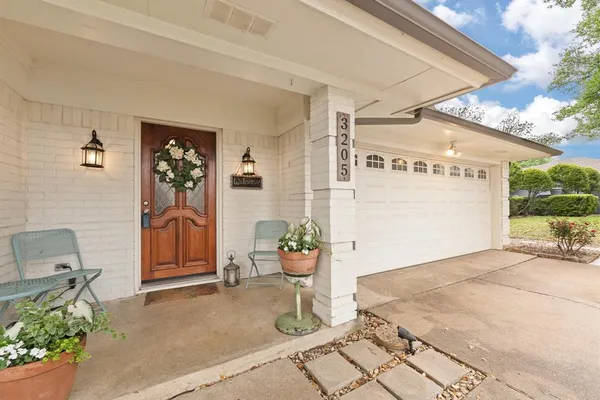 a bedroom with a bed and potted plant