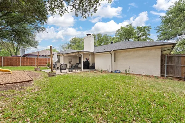a view of a house with backyard and sitting area