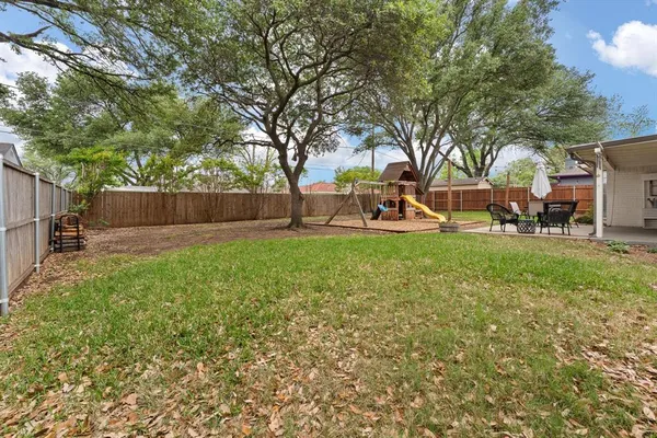 a view of a backyard with a garden and trees