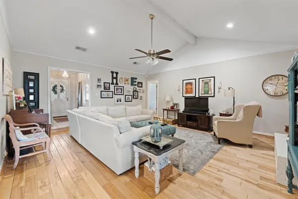 a living room with furniture a rug and a chandelier