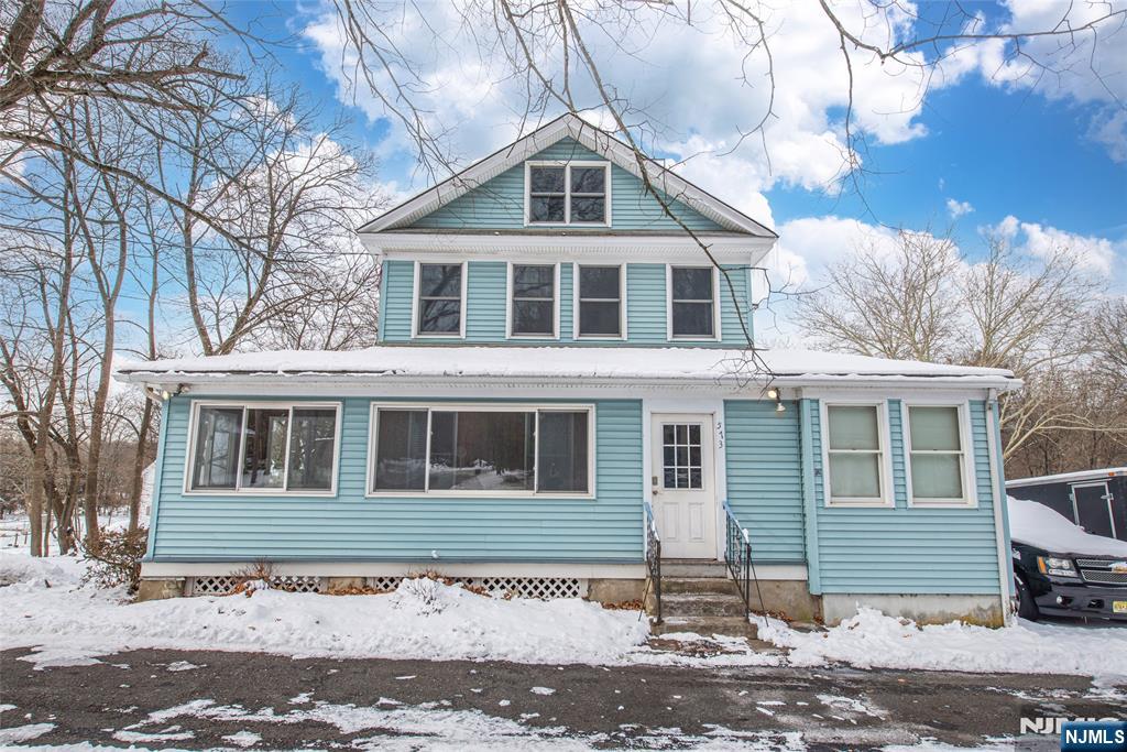 573 Wyckoff Avenue Mahwah, NJ 07430 - Photo 1 of 30 a front view of a house with a yard