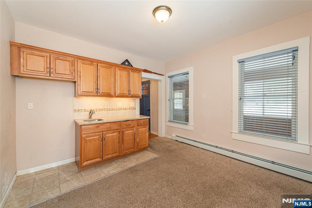 573 Wyckoff Avenue Mahwah, NJ 07430 - Photo 11 of 30 a kitchen with granite countertop a sink and a stove top oven