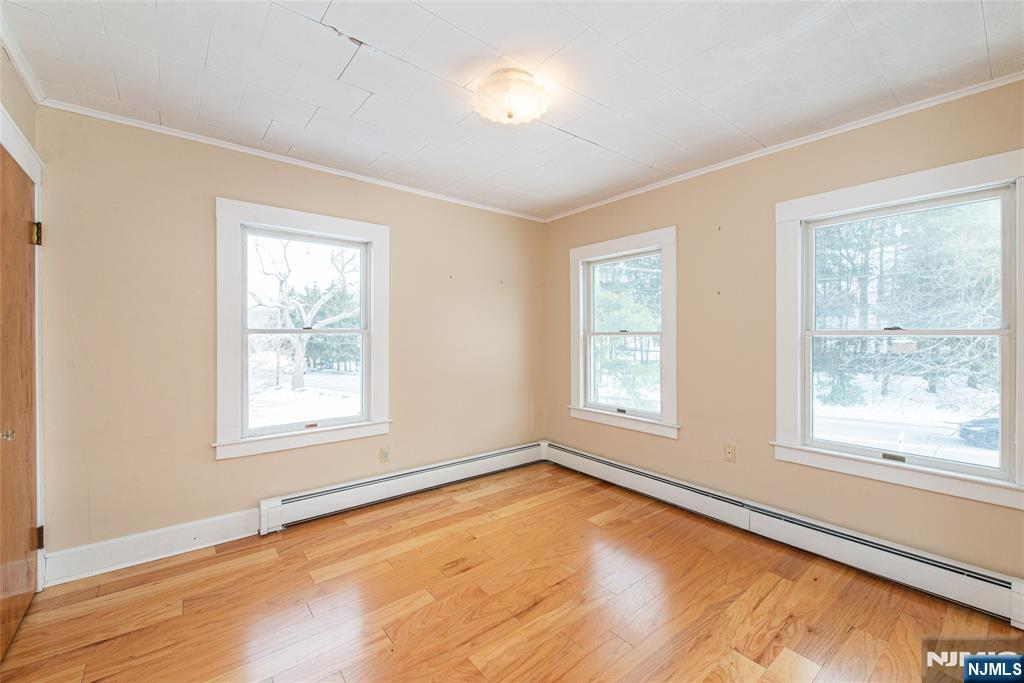573 Wyckoff Avenue Mahwah, NJ 07430 - Photo 17 of 30 a view of an empty room with wooden floor and a window