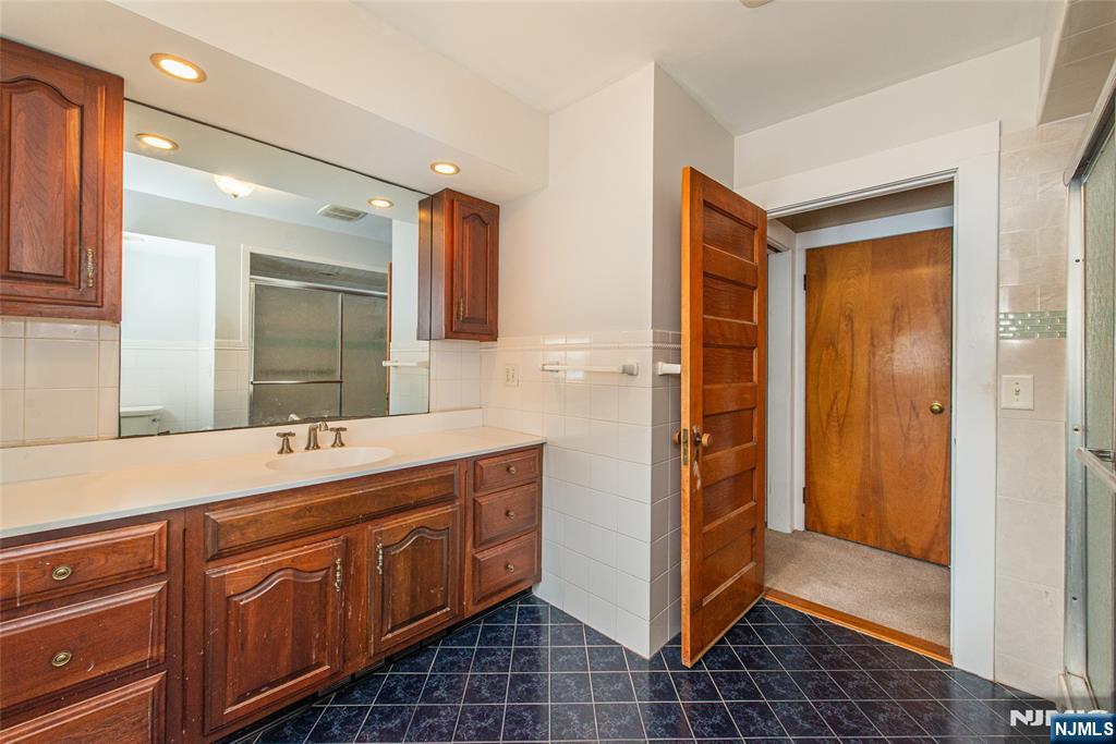 573 Wyckoff Avenue Mahwah, NJ 07430 - Photo 20 of 30 a bathroom with a double vanity sink and a mirror