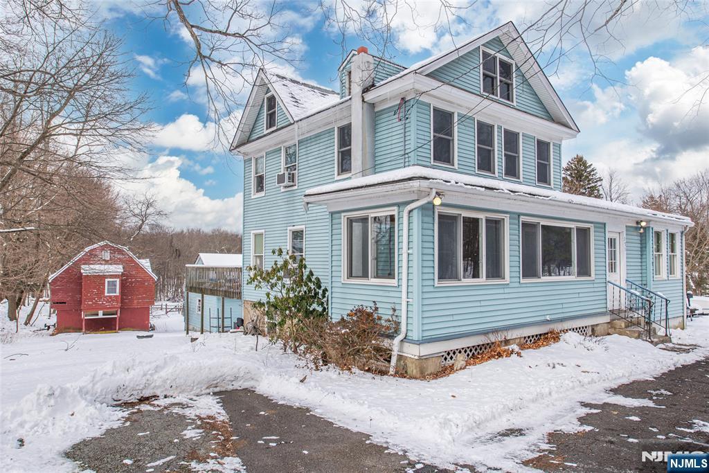 573 Wyckoff Avenue Mahwah, NJ 07430 - Photo 2 of 30 a front view of a house with a yard