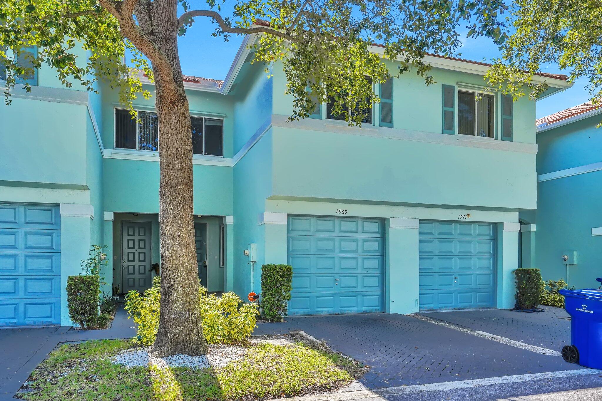 1969 Alamanda Way, Unit 1969 Riviera Beach, FL 33404 - Photo 15 of 26 a front view of a house with a yard and garage