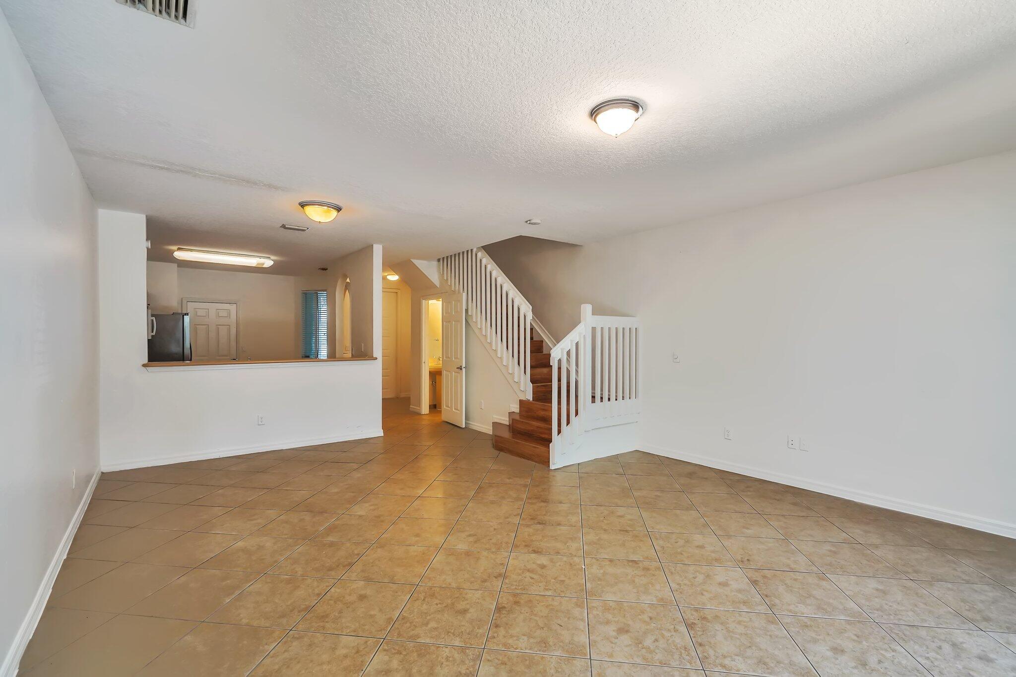 1969 Alamanda Way, Unit 1969 Riviera Beach, FL 33404 - Photo 2 of 26 a view of a hallway with staircase