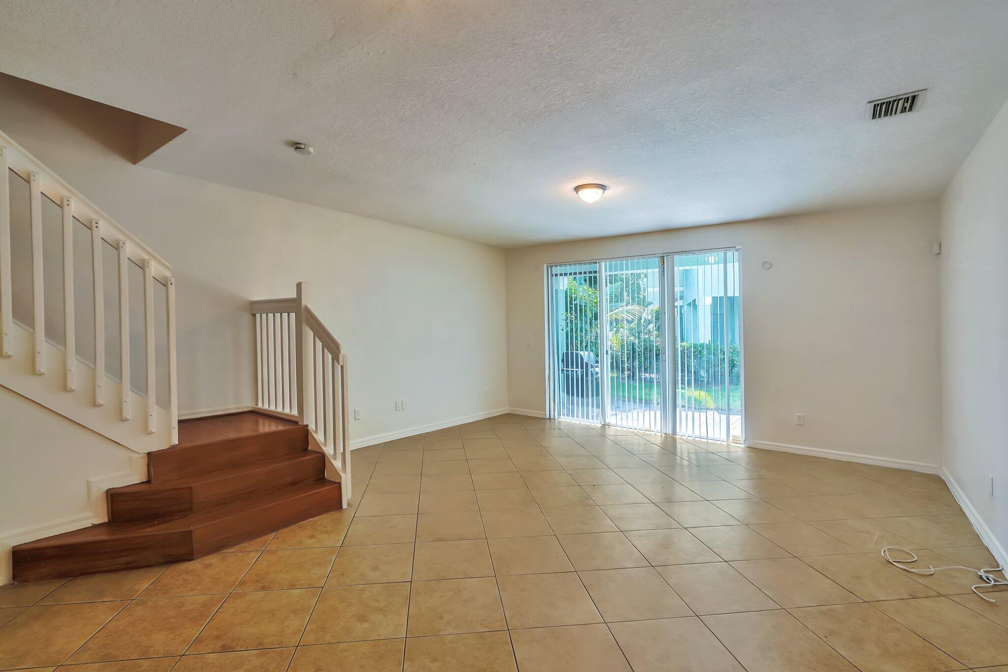 1969 Alamanda Way, Unit 1969 Riviera Beach, FL 33404 - Photo 3 of 26 a view of an entryway with wooden floor