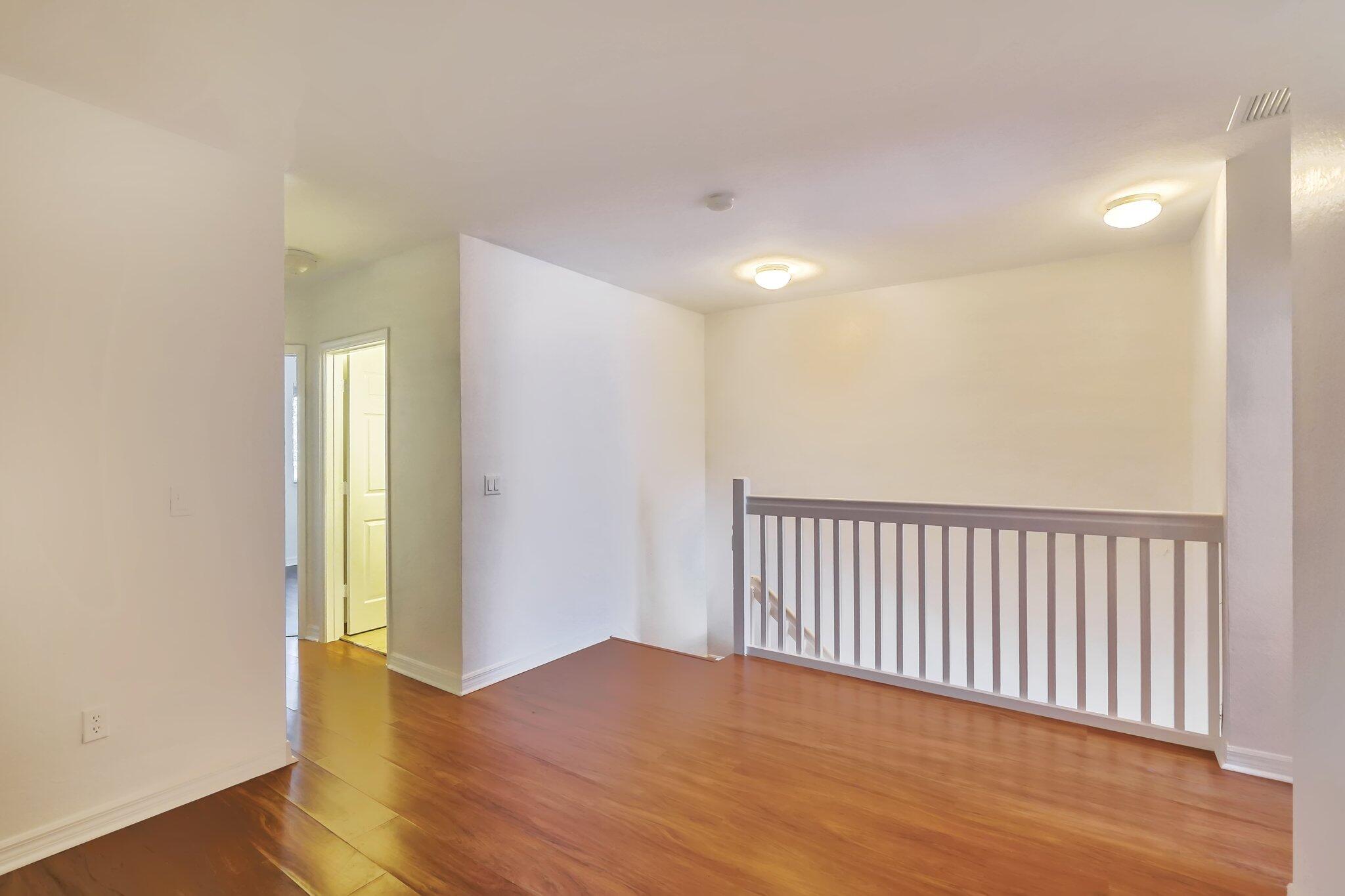 1969 Alamanda Way, Unit 1969 Riviera Beach, FL 33404 - Photo 10 of 26 a view of a hallway with wooden floor