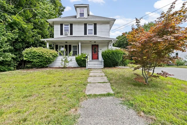 a front view of house with yard and green space