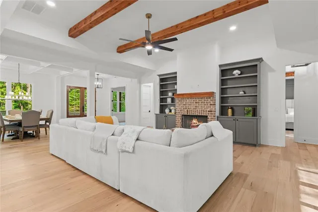 a kitchen with stainless steel appliances kitchen island a sink cabinets a refrigerator and a sink