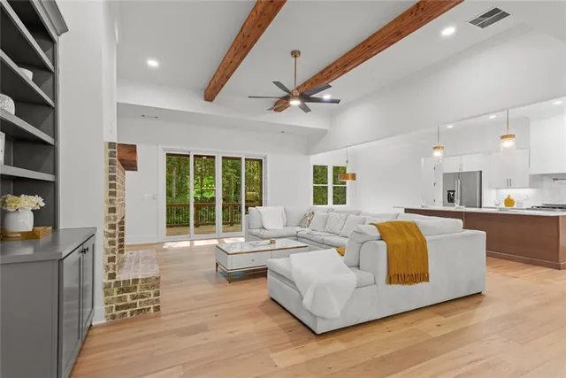 a kitchen with a sink a stove a refrigerator and white cabinets