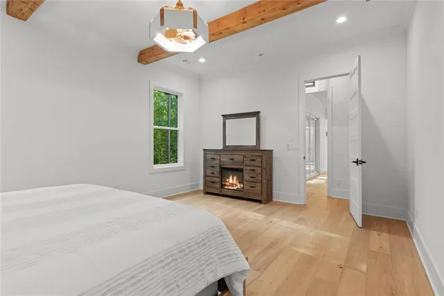 a bed sitting in a bedroom next to a window