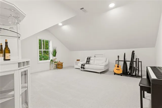 a view of a swimming pool with a big yard and large trees