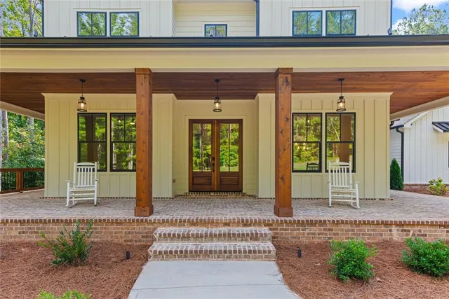 a view of a porch with a table and chairs