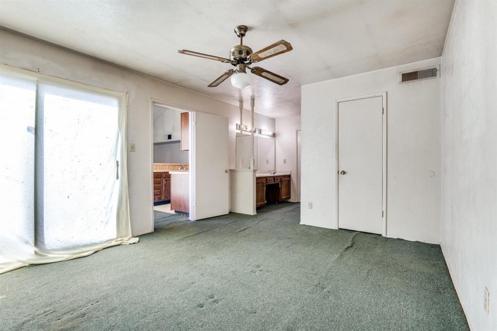7049 Sorcey Road Dallas, TX 75249 - Photo 2 of 12 an empty room with a ceiling fan and closet area