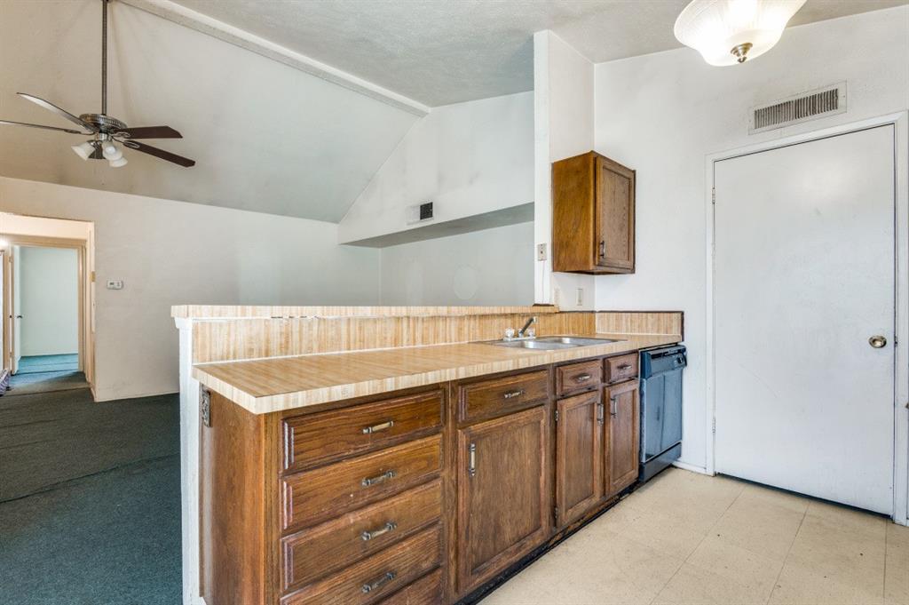 7049 Sorcey Road Dallas, TX 75249 - Photo 5 of 12 a bathroom with a sink and a mirror