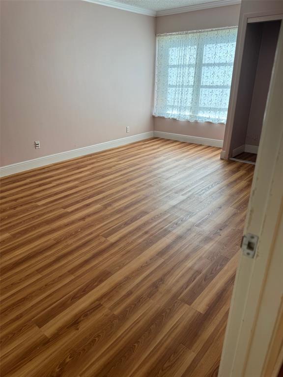 3774 Inverrary Boulevard, Unit 106P Lauderhill, FL 33319 - Photo 16 of 29 wooden floor in an empty room with a window