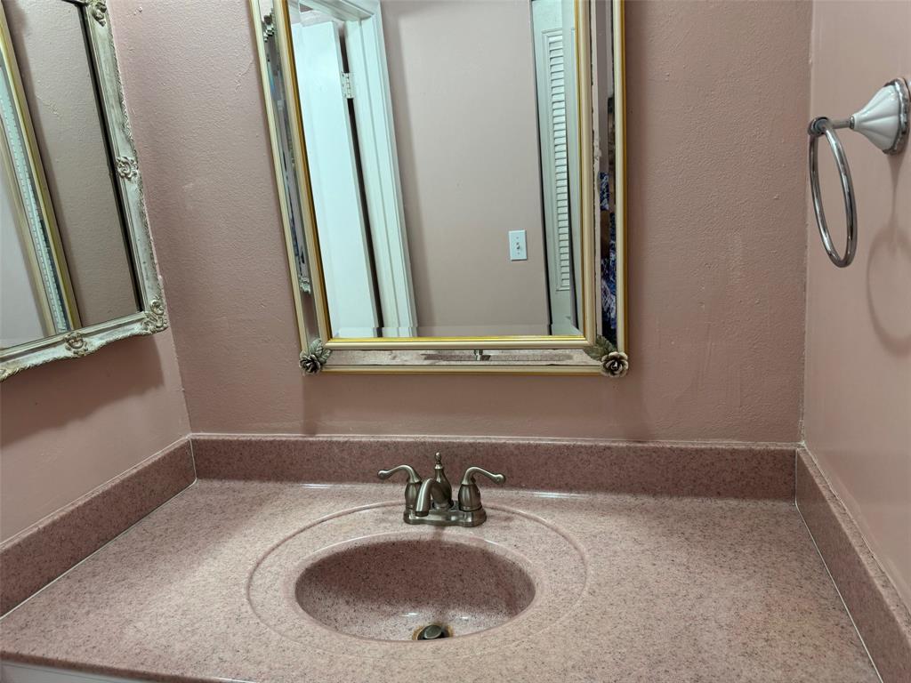 3774 Inverrary Boulevard, Unit 106P Lauderhill, FL 33319 - Photo 20 of 29 a bathroom with a sink and a mirror