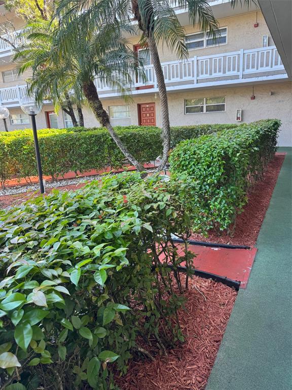 3774 Inverrary Boulevard, Unit 106P Lauderhill, FL 33319 - Photo 27 of 29 a view of a house with a yard and potted plants