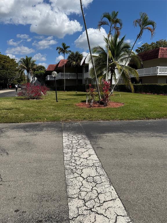 3774 Inverrary Boulevard, Unit 106P Lauderhill, FL 33319 - Photo 28 of 29 a view of a park with plants and a car parked