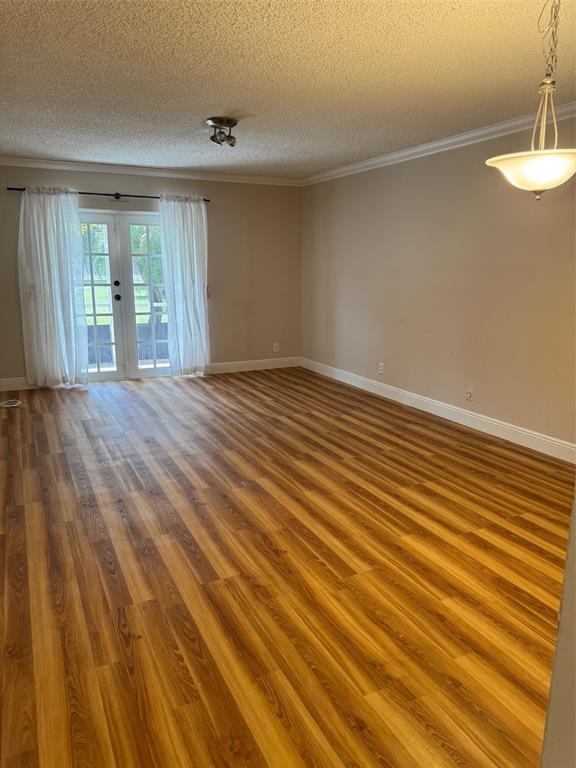 3774 Inverrary Boulevard, Unit 106P Lauderhill, FL 33319 - Photo 5 of 29 wooden floor in an empty room with a window