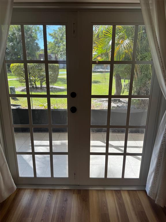 3774 Inverrary Boulevard, Unit 106P Lauderhill, FL 33319 - Photo 6 of 29 a view of an empty room with wooden floor and a window