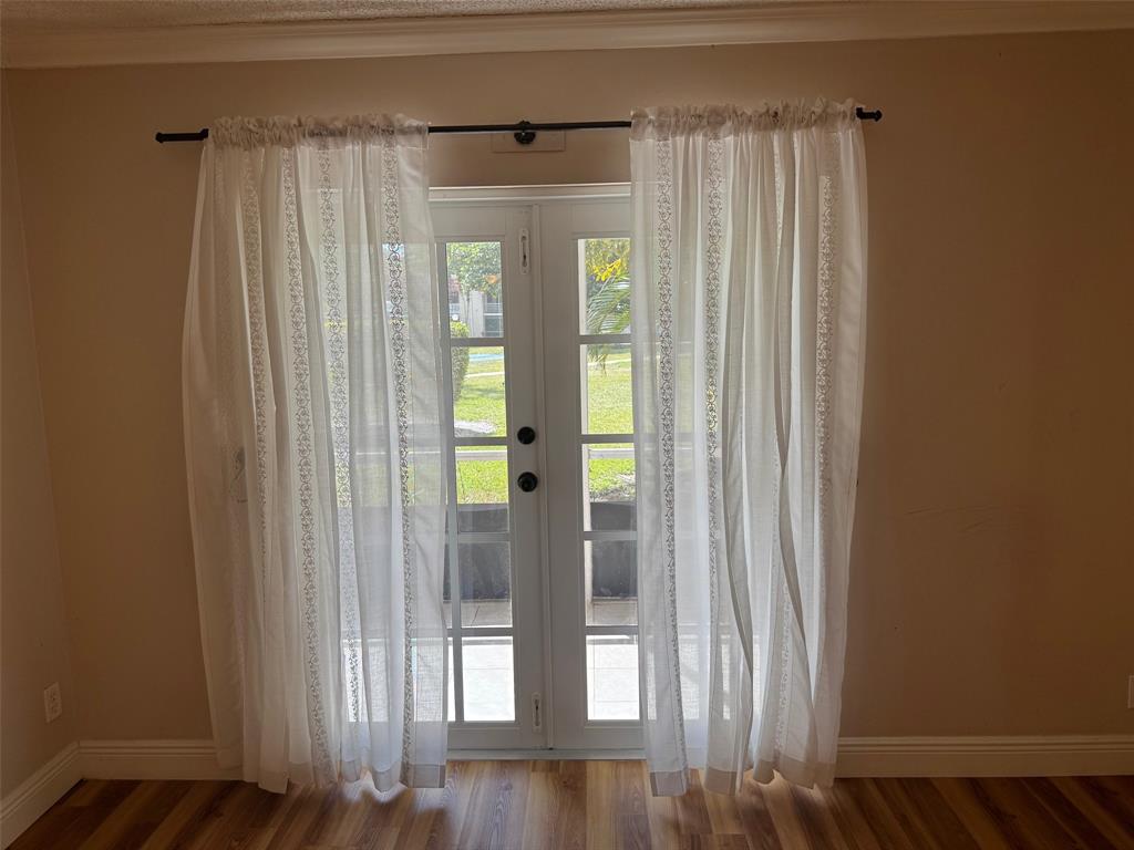 3774 Inverrary Boulevard, Unit 106P Lauderhill, FL 33319 - Photo 8 of 29 a view of entryway with wooden floor and door