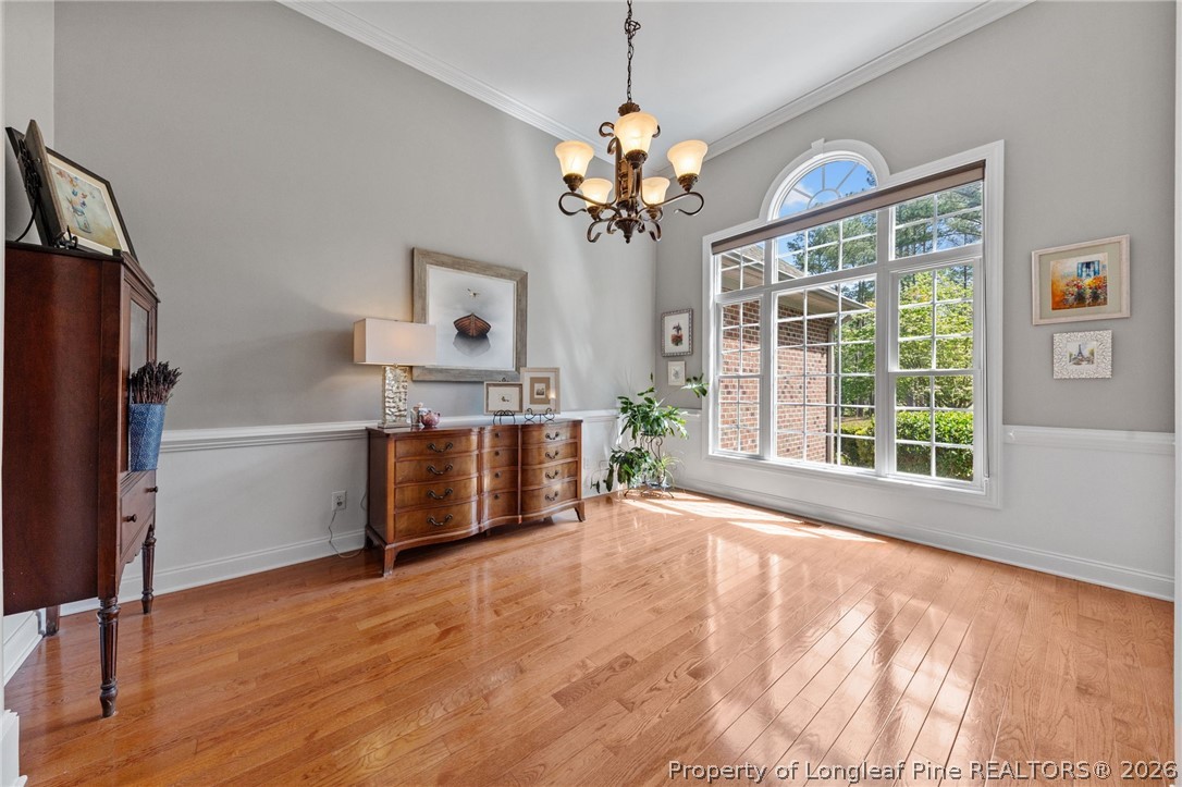 30180 East Lake Road Wagram, NC 28396 - Photo 20 of 42 a room with chandelier and wooden floor