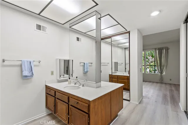 a bathroom with a sink a mirror and a shower