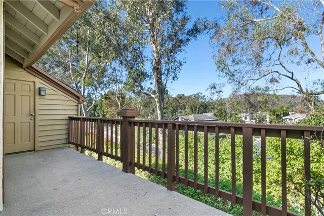 a view of a balcony with wooden fence and floor