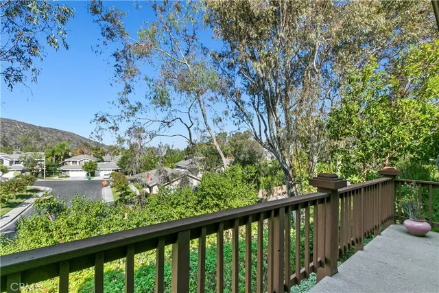 a view of swimming pool with chairs and umbrella