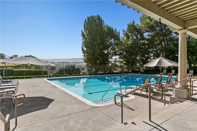 a swimming pool with outdoor seating and yard