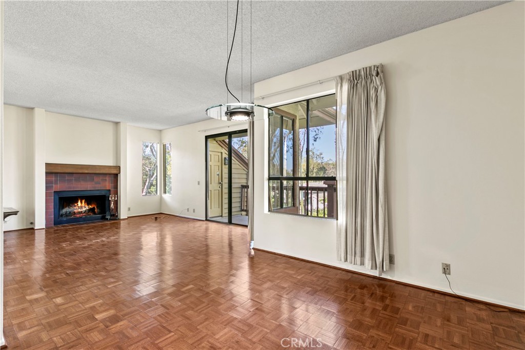 51 Rainbow Irvine, CA 92603 - Photo 7 of 25 a view of an empty room with a fireplace and a window