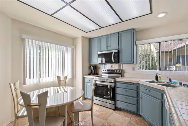 a kitchen with a stove a sink and a microwave