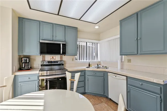 a kitchen with a sink stove and microwave